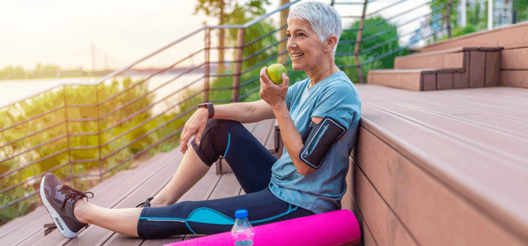 woman eating an apple after exercising