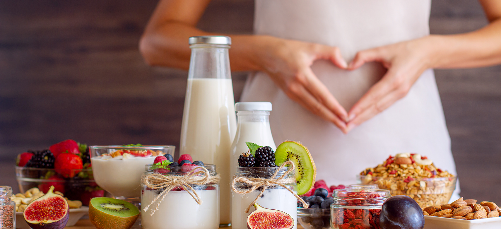 woman eating yogurt and healthy foods for gut health